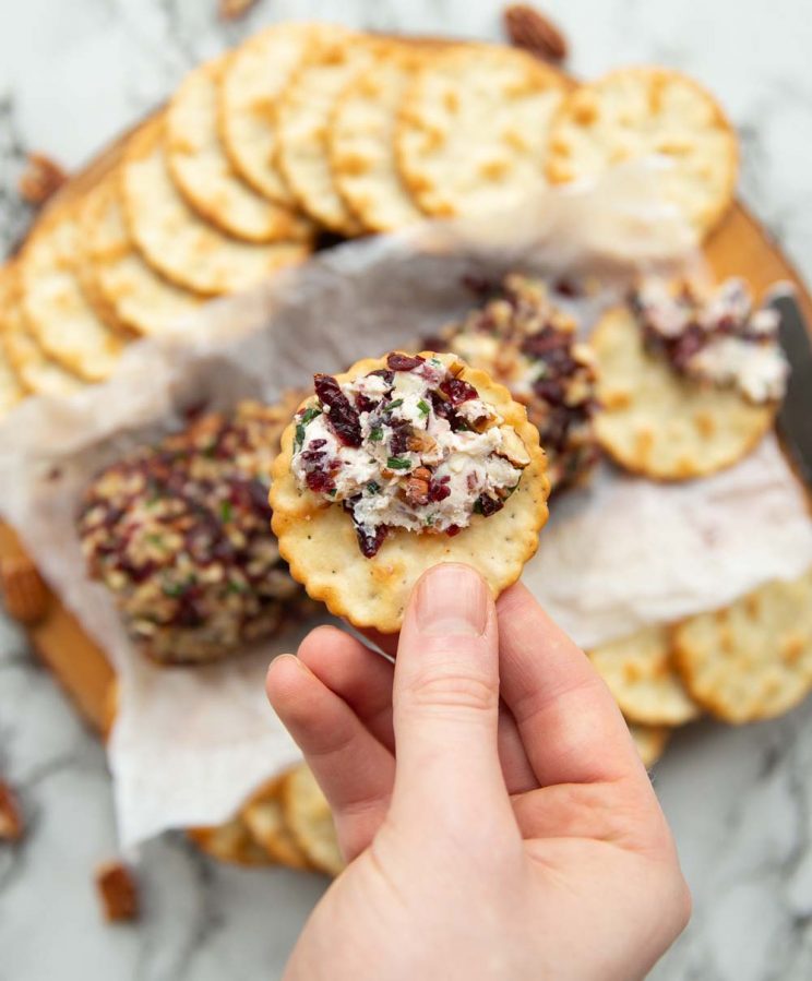 overhead shot of cheese on cracker above board