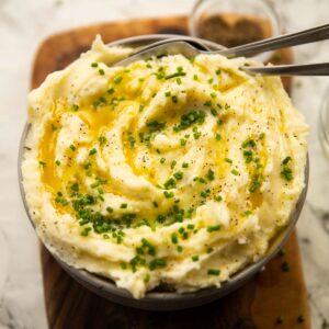 Boursin mash served in bowl with melted butter and chives