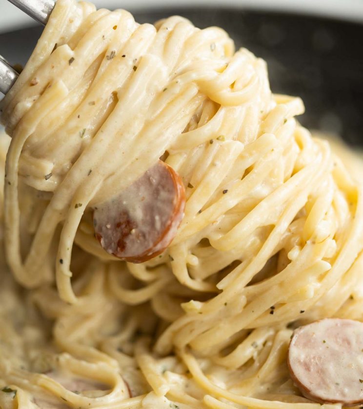 close up shot of pasta tongs twizzling pasta