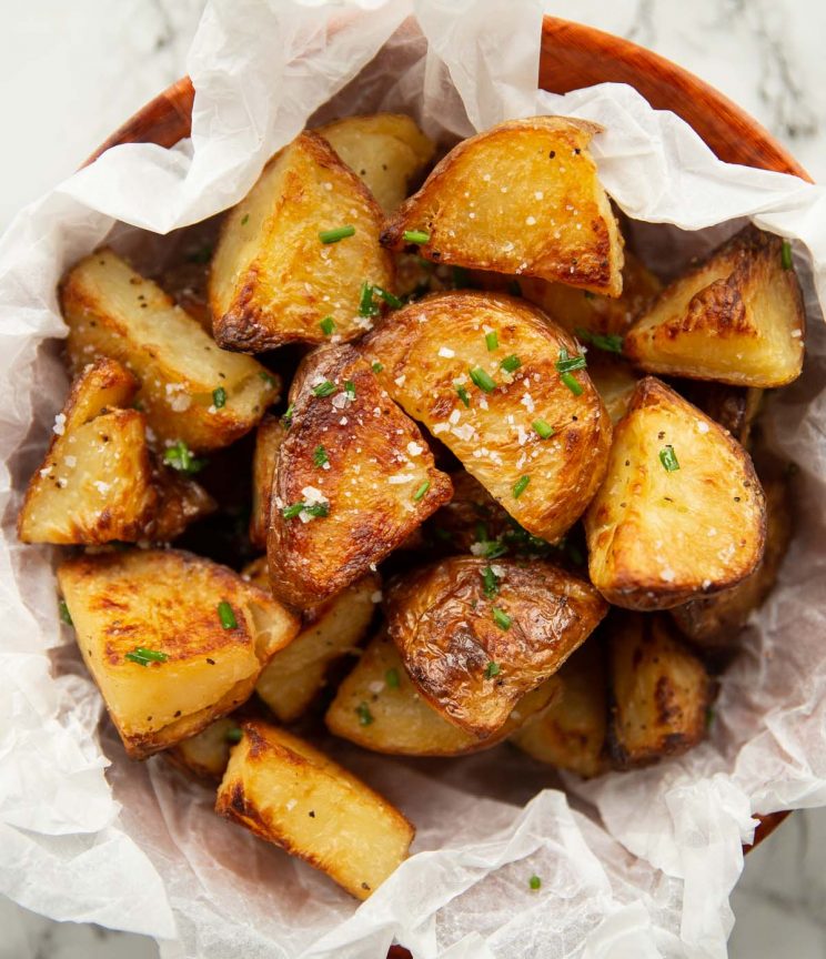 overhead shot of potatoes in scrunched up parchment paper