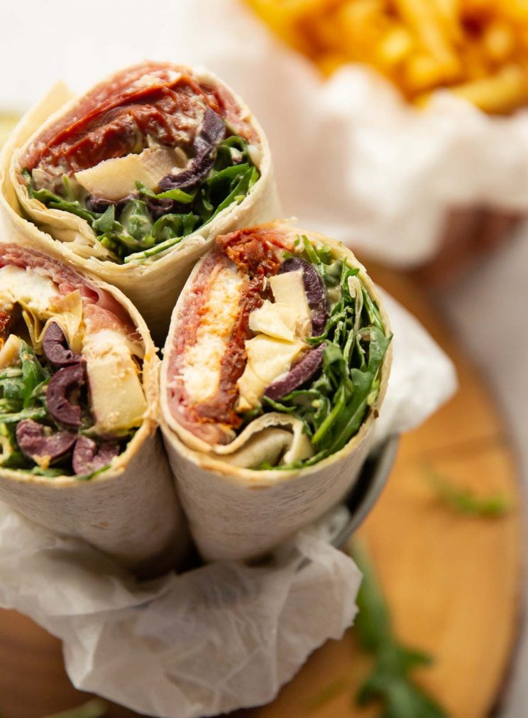 closeup shot of wrap showing filling with fries blurred in background