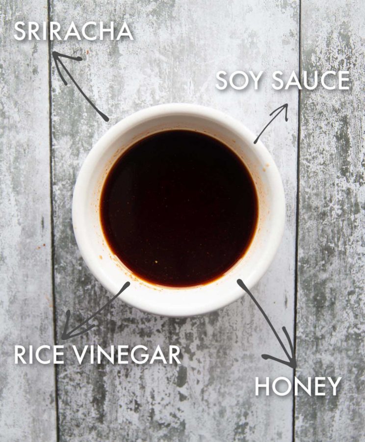 honey sriracha soy sauce in small white pot with ingredient labels