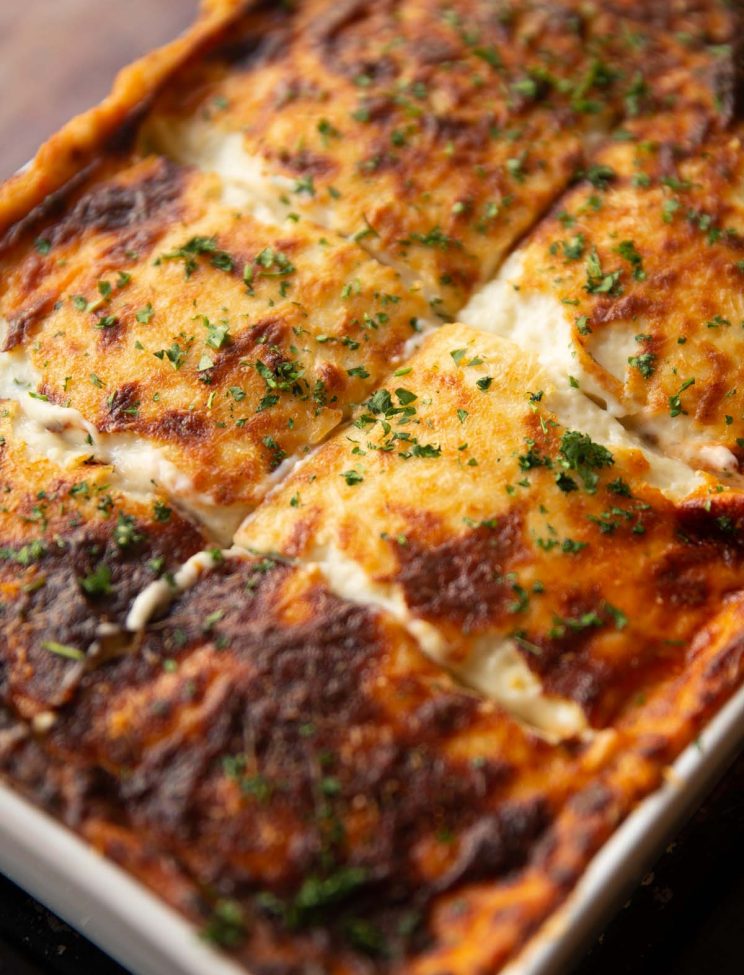 close up shot of knife slices in moussaka fresh out the oven