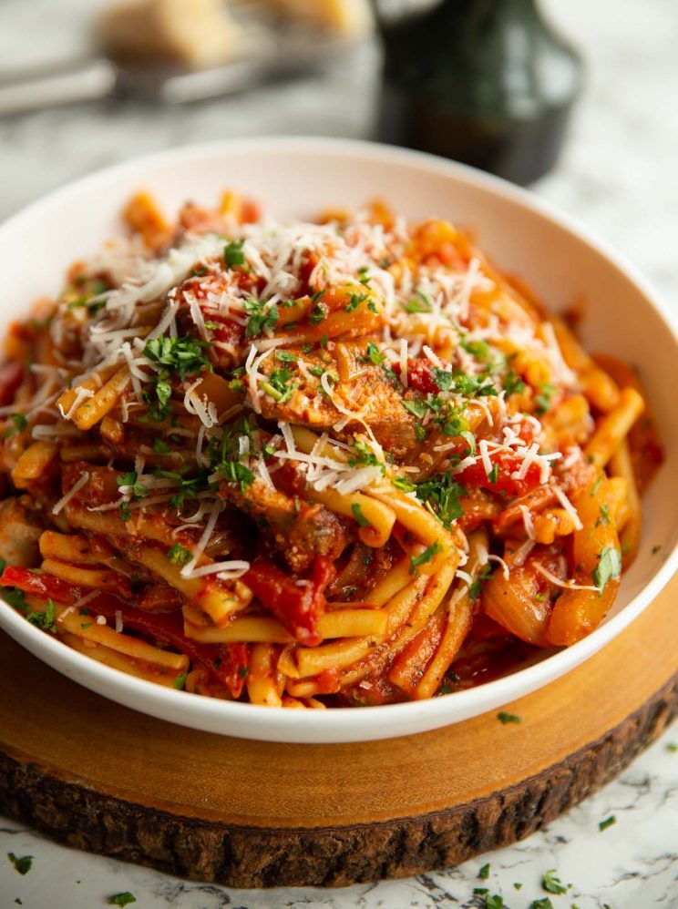 pasta served in large white bowl on wooden board