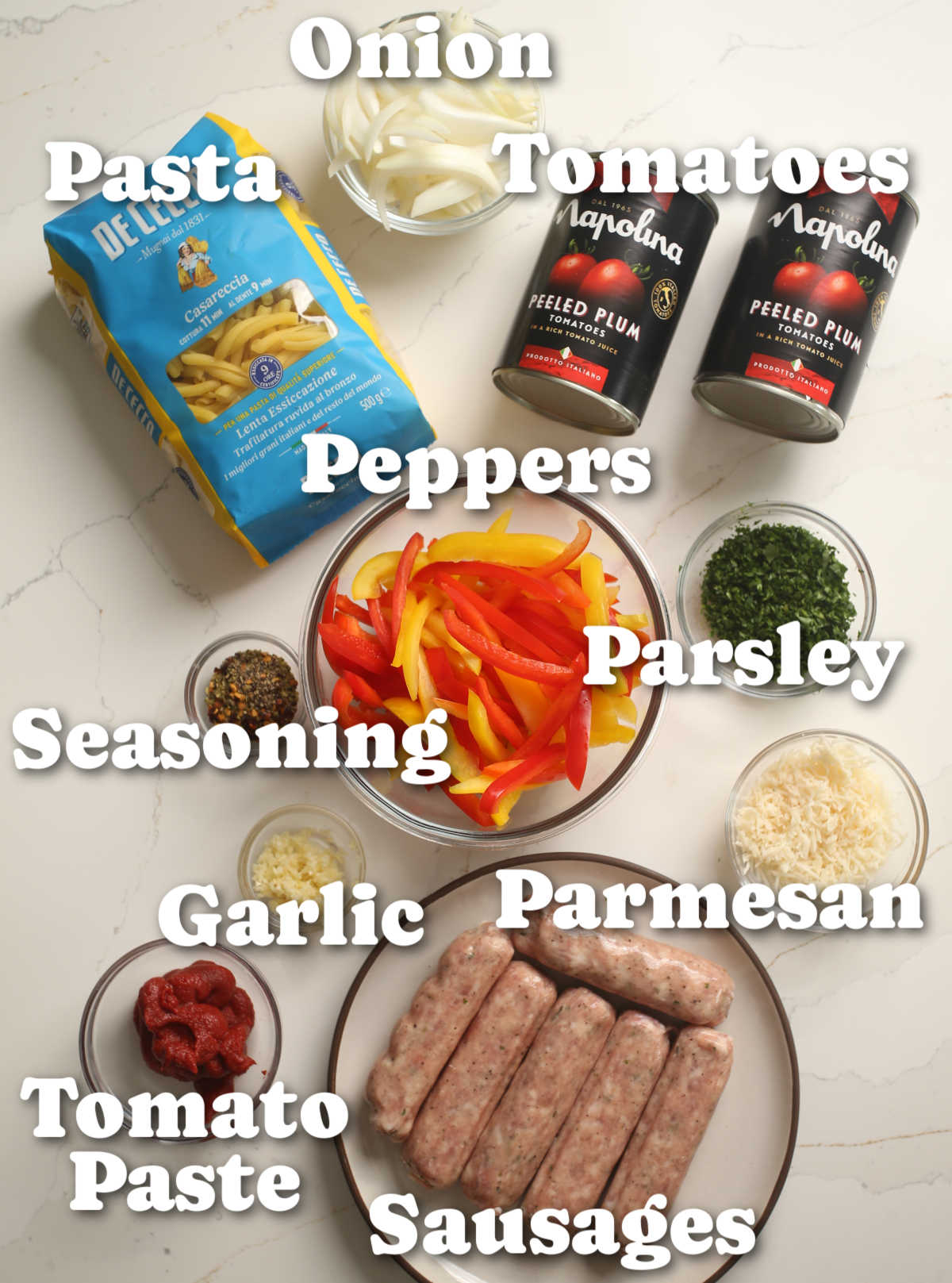 overhead shot of sausage and peppers pasta ingredients with text labels