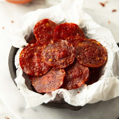 pepperoni chips in parchment paper in mini cast iron skillet