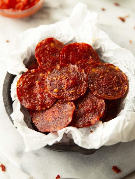 pepperoni chips in parchment paper in mini cast iron skillet