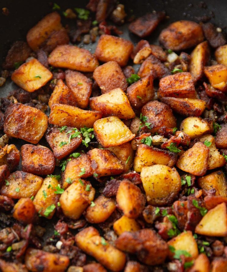 breakfast potatoes in large skillet garnished with fresh parsley
