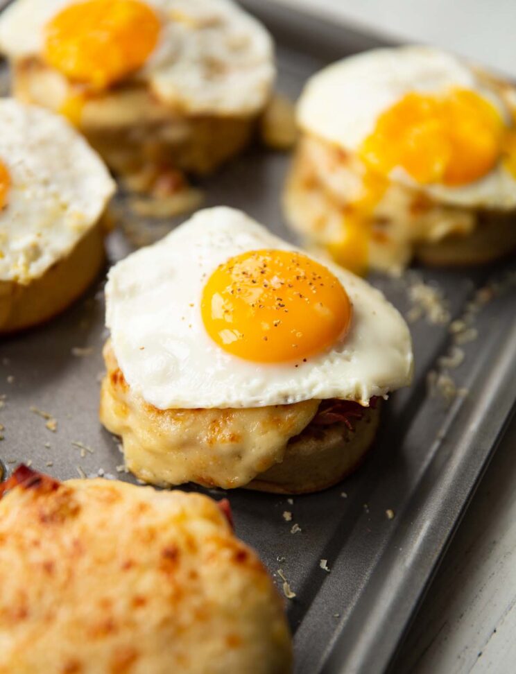 6 madame crumpets on baking tray served with fried egg on top