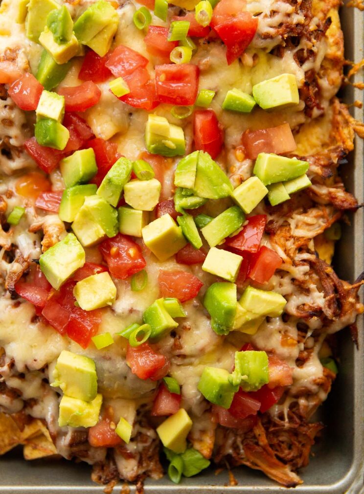 overhead shot of pulled pork nachos in silver baking tray