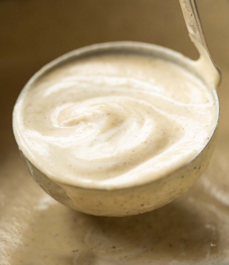 close up shot of ladle in big pot of cauliflower soup