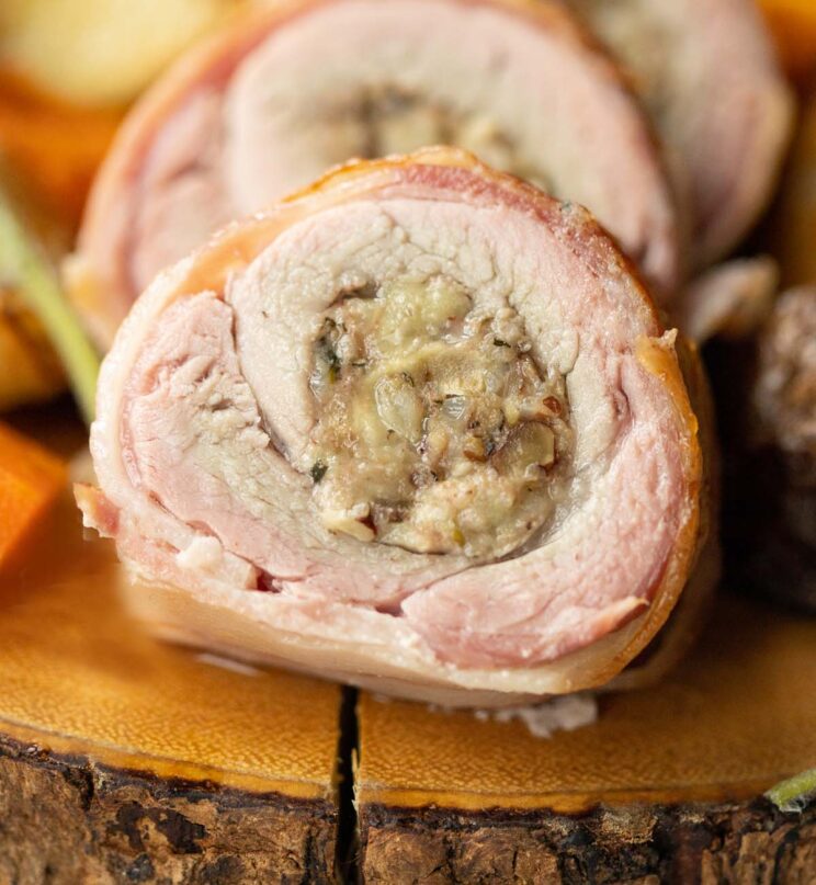 close up shot of sliced pork tenderloin on wooden board