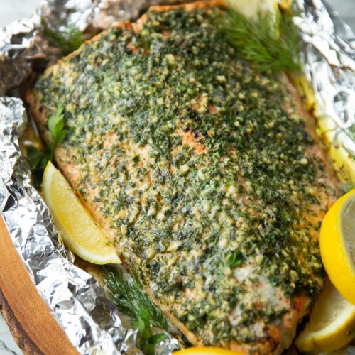 baked salmon wrapped in foil fresh out the oven garnished with lemon wedges