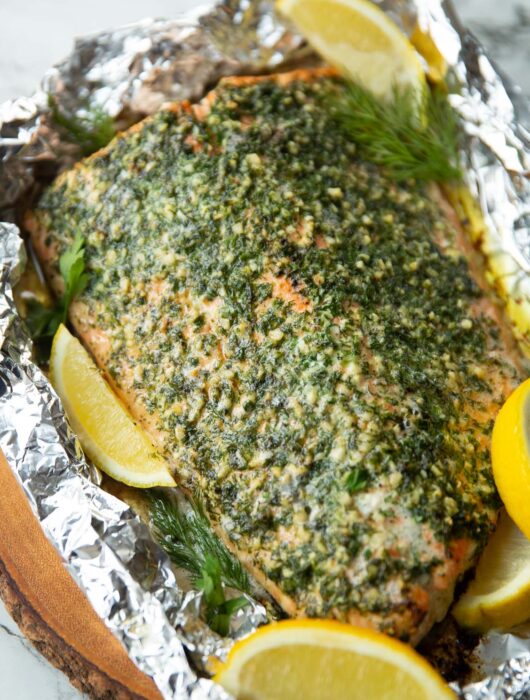 baked salmon wrapped in foil fresh out the oven garnished with lemon wedges