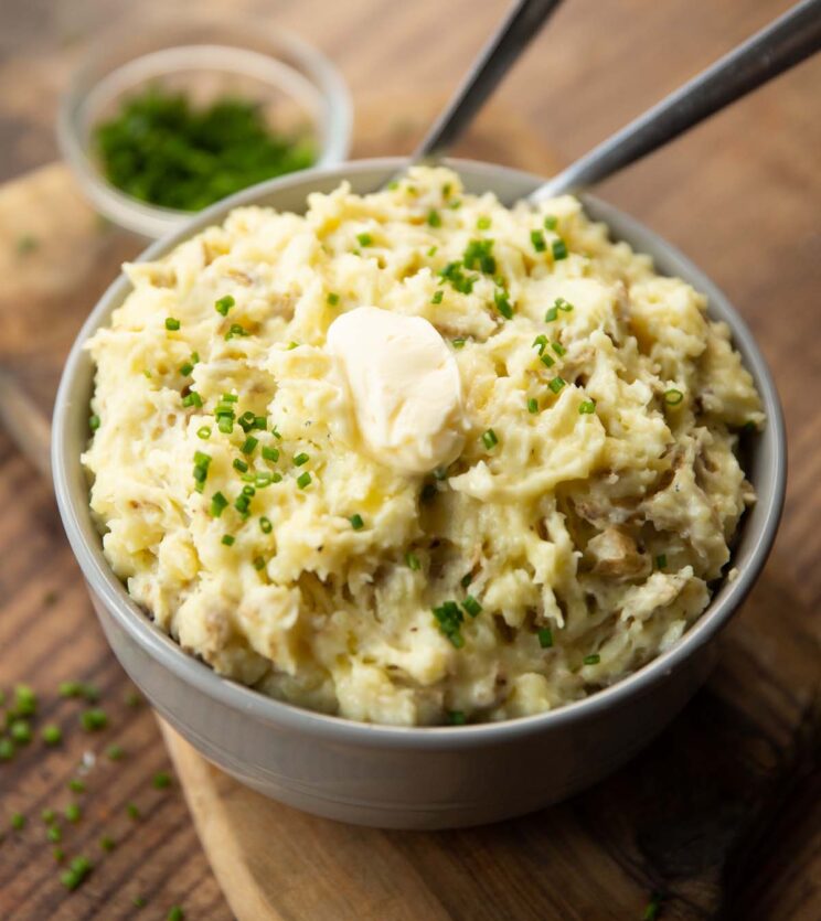 skin on mashed potatoes in large grey bowl with two silver forks digging in 
