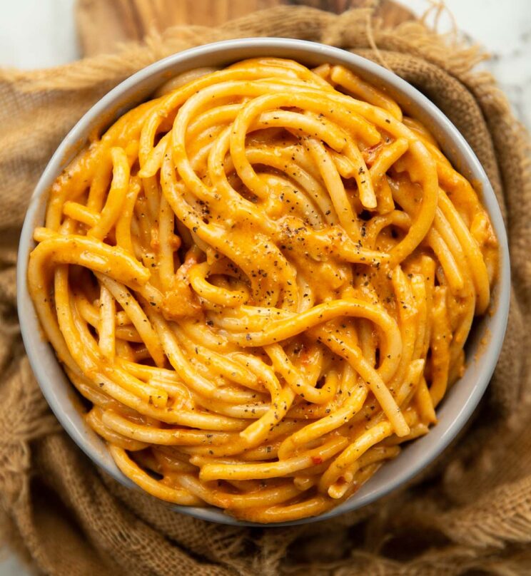 overhead shot of tomato cream pasta in large grey bowl 