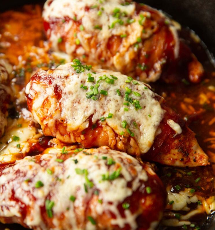 close up shot of hunters chicken fresh out the oven in skillet with fresh chives