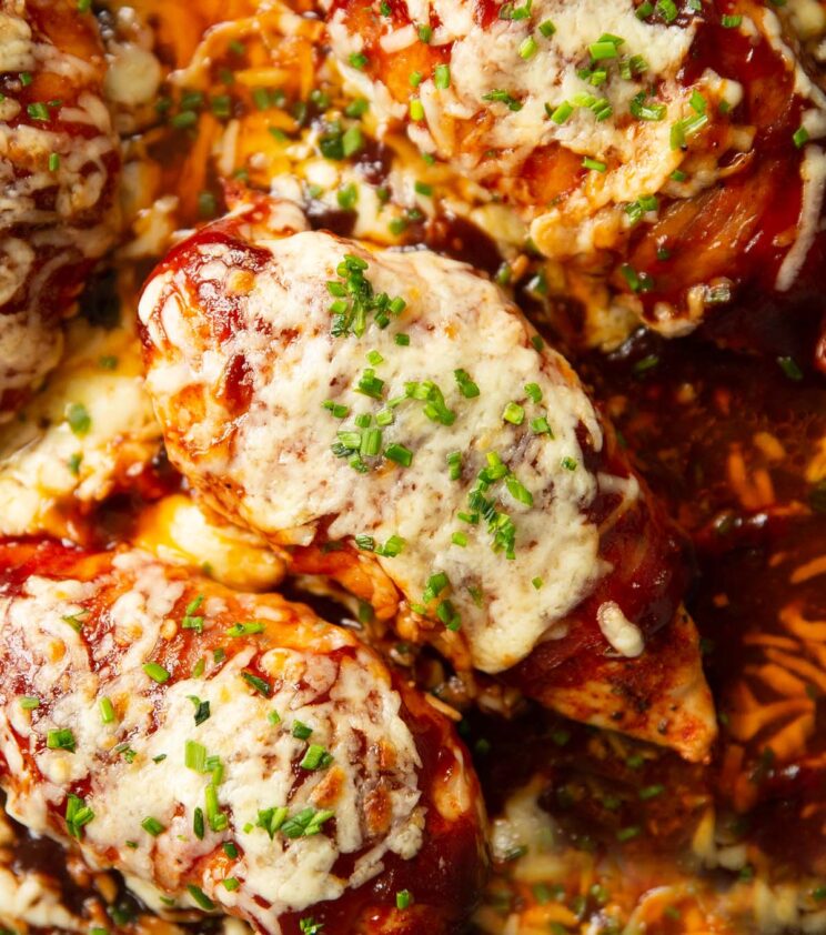 close up overhead shot of hunters chicken in skillet garnished with chives