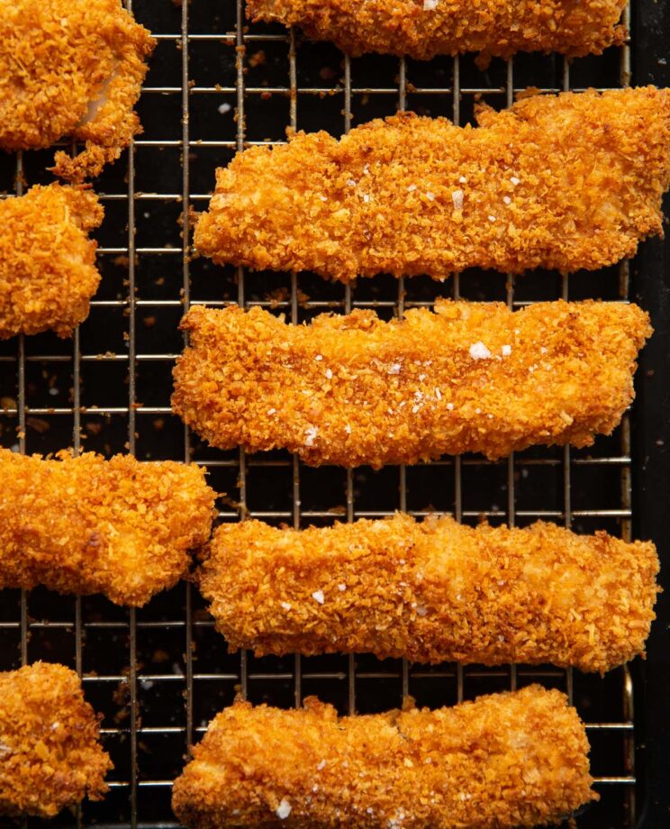 close up overhead shot of fish fingers fresh out the oven on wire rack