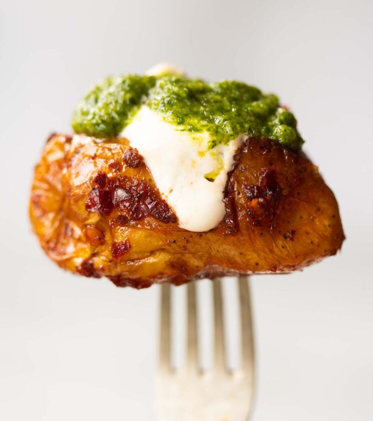close up shot of silver fork holding Nduja pesto potato