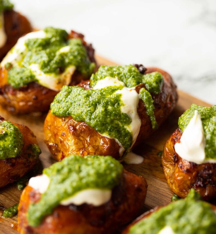 close up shot of Nduja pesto potatoes on wooden chopping board focus on one