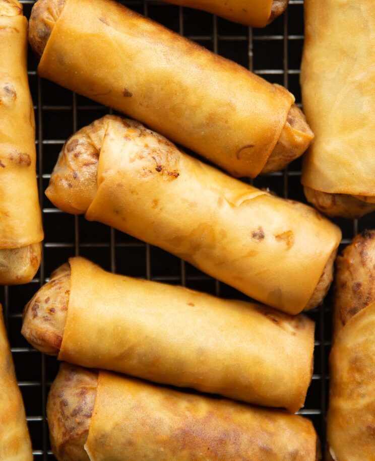 close up overhead shot of spring roll on wire rack fresh out the fryer