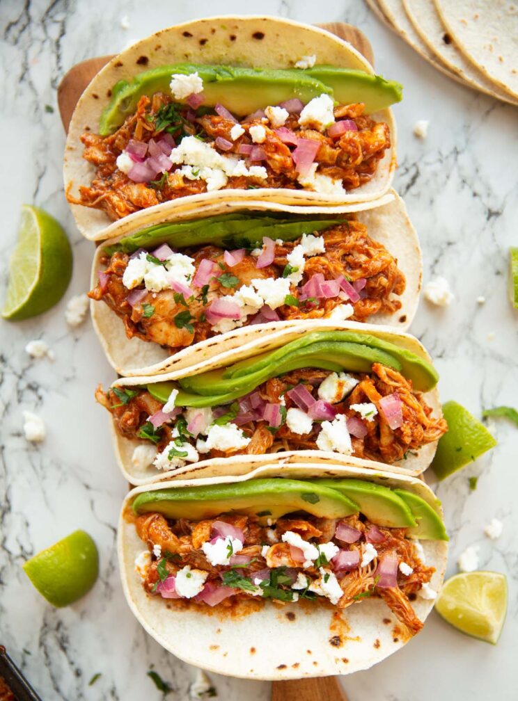 overhead shot of 4 honey chipotle chicken tacos on marble backdrop 