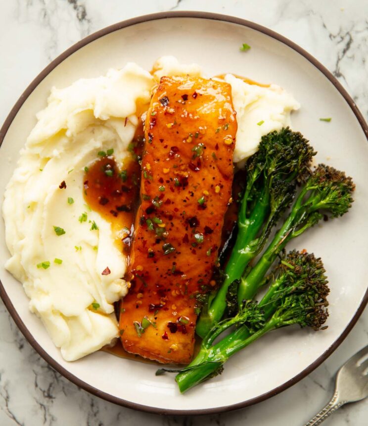 overhead shot of salmon fillet served with mashed potatoes and broccolini