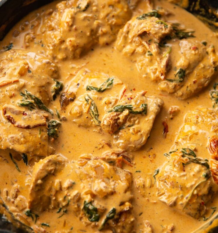 creamy cajun chicken in a large cast iron skillet