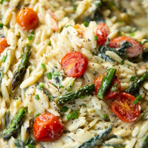 close up shot of baked feta orzo in large pan