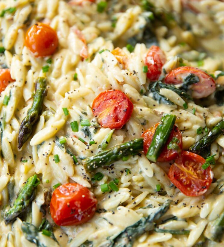 close up shot of baked feta orzo in large pan