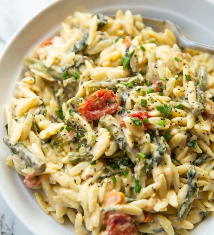 baked feta orzo in a large white bowl