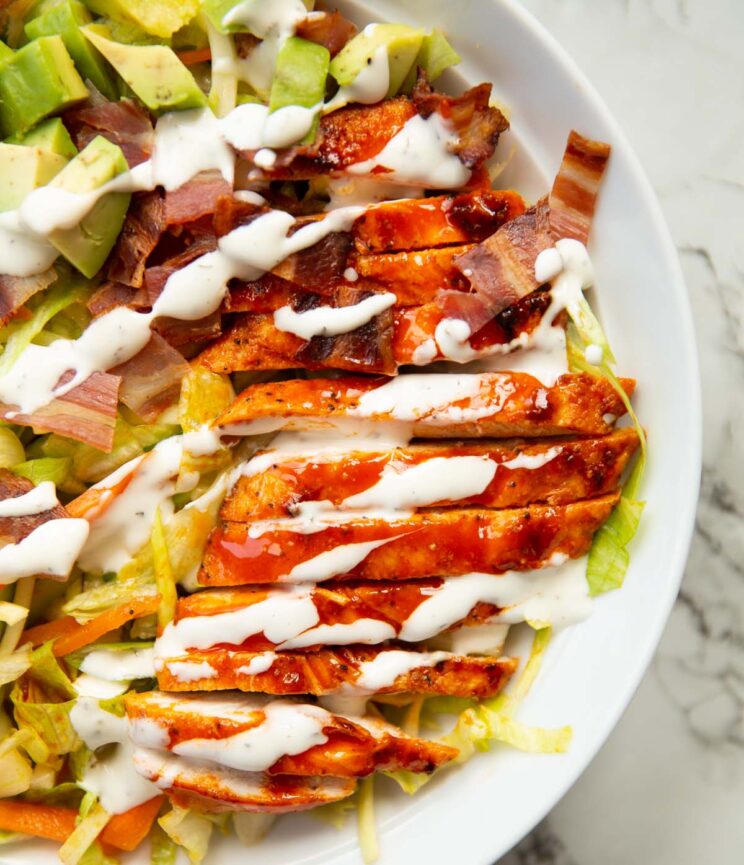 close up overhead shot of buffalo chicken salad in large white dish