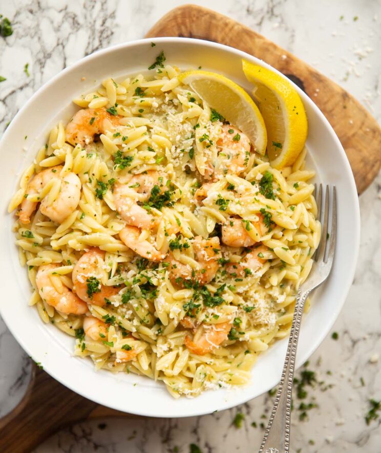 overhead shot of garlic butter prawn orzo in large white bowl