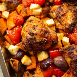 close up shot of peri peri chicken traybake fresh out the oven
