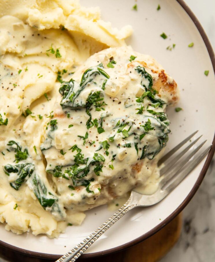 close up shot of Boursin chicken on small white plate with mashed potato