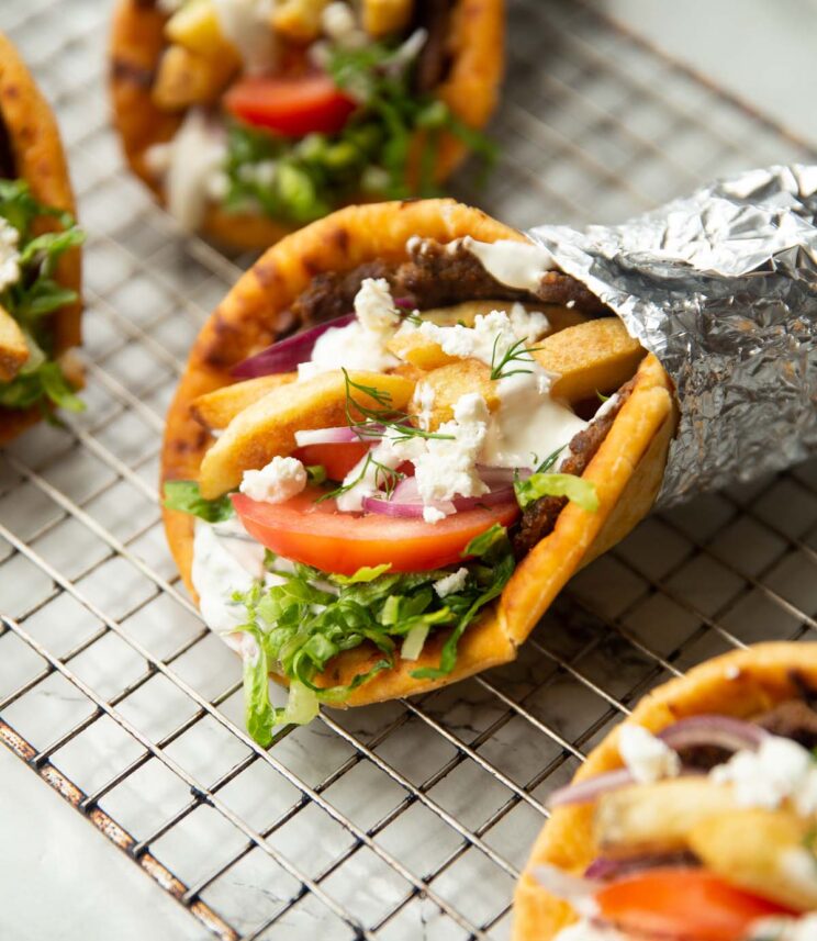 close up shot of ground beef gyros on wire rack in foil