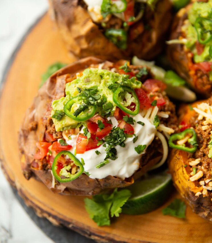 close up shot of taco sweet potatoes on wooden board