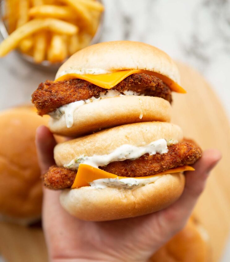 overhead shot of hand holding two filet-o-fish sandwiches
