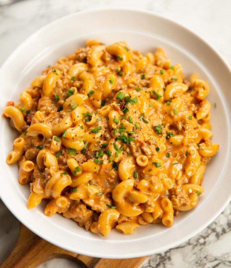 hamburger helper served in a large white bowl with fresh chives