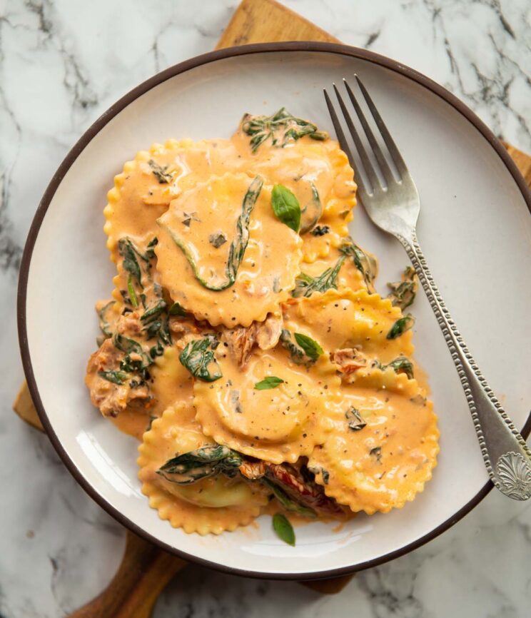 overhead shot of Tuscan pasta on small white plate with silver fork