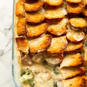 overhead shot of cheesy broccoli chicken bake with portion taken out