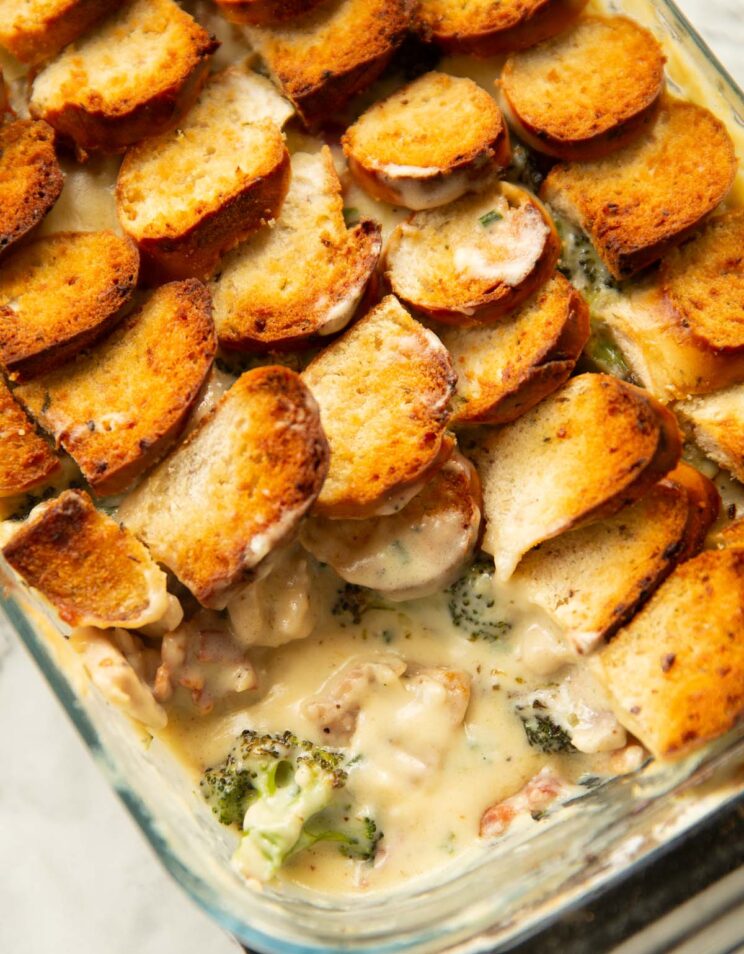 close up shot of cheesy chicken broccoli bake with scoop taken out