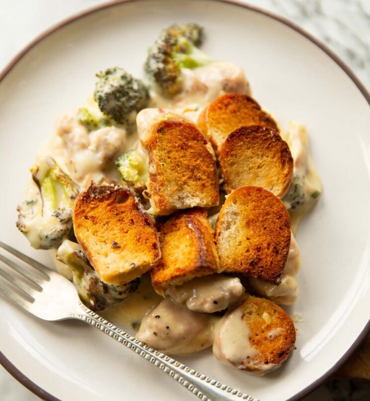 chicken and broccoli bake served on small white plate with silver fork