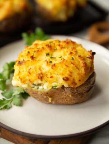 fish pie baked potato on white plate with parsley