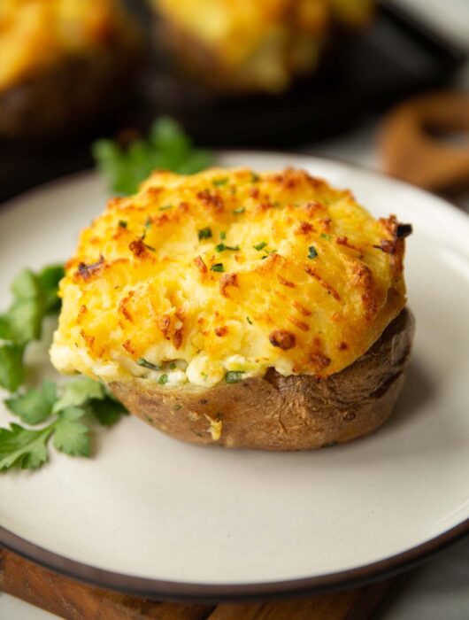 fish pie baked potato on white plate with parsley