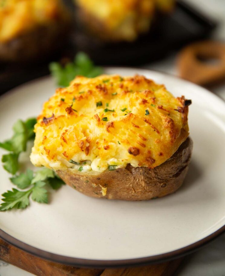 fish pie baked potato on white plate with parsley