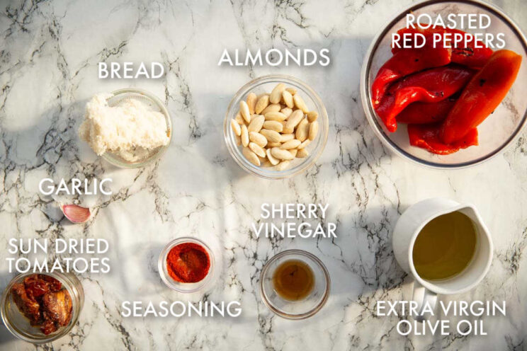 overhead shot of romesco sauce ingredients with text labels