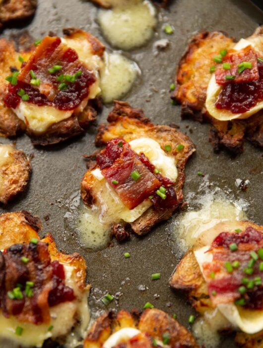 brie bacon cranberry smashed potatoes on baking tray fresh out the oven