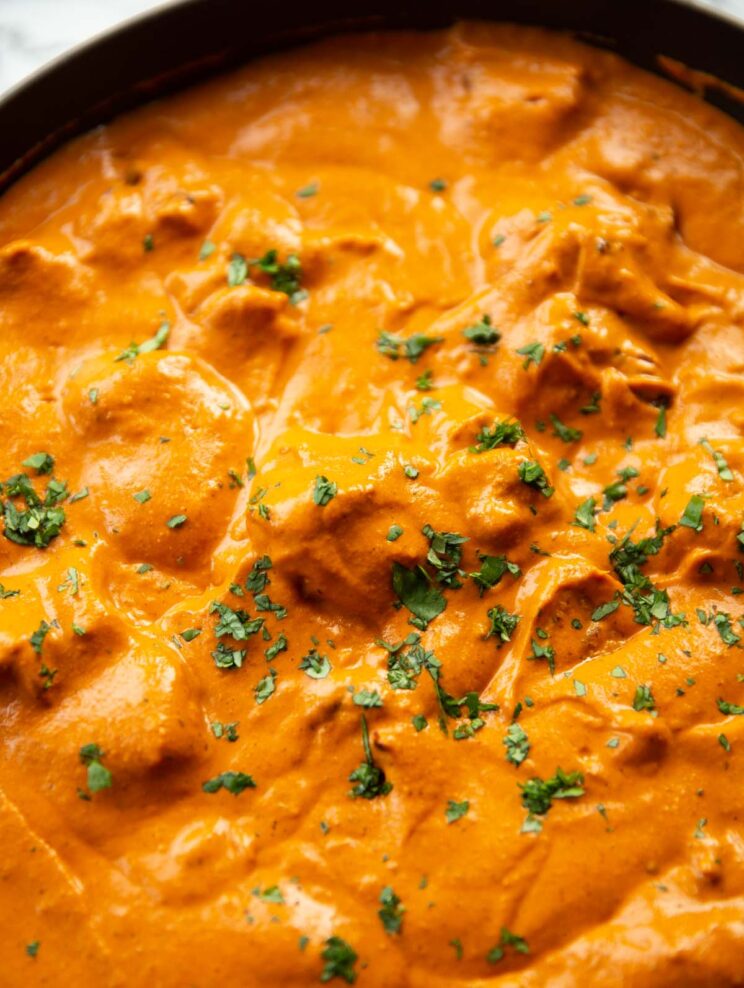 close up shot of butter chicken in large frying pan